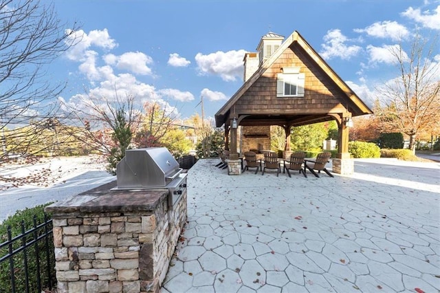 view of patio with an outdoor hangout area, grilling area, and exterior kitchen