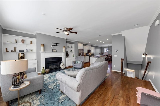 living room with crown molding, ceiling fan, and hardwood / wood-style flooring