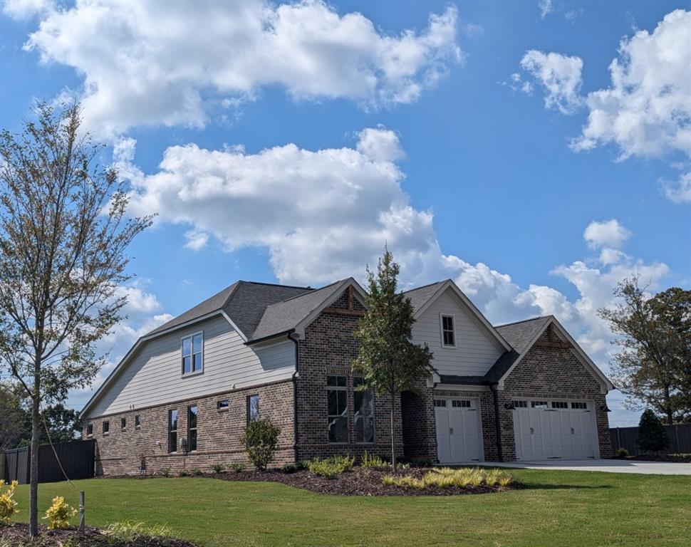 view of front of property featuring a garage and a front lawn