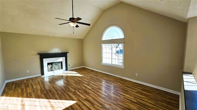 unfurnished living room with dark wood-type flooring, a textured ceiling, high vaulted ceiling, and ceiling fan