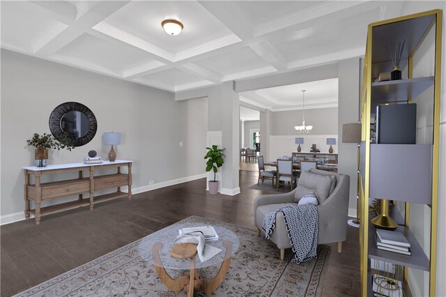 living area with dark wood-type flooring, a notable chandelier, beam ceiling, and coffered ceiling