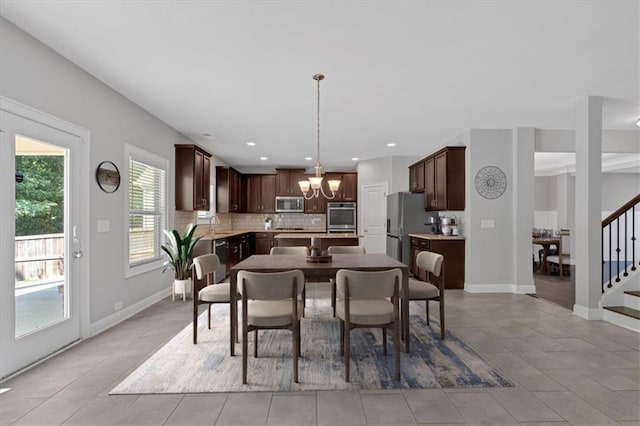 dining area with recessed lighting, stairs, baseboards, and an inviting chandelier