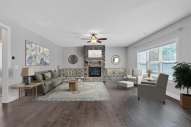 living room with baseboards, a fireplace, a ceiling fan, visible vents, and wood finished floors