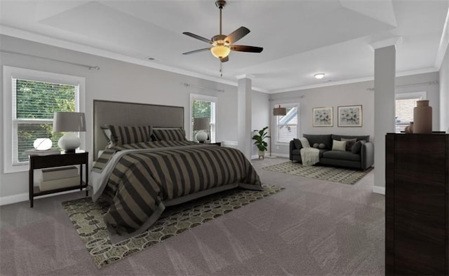 carpeted bedroom featuring crown molding, a tray ceiling, baseboards, and a ceiling fan
