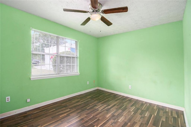 256 Olde Oaks Ln, Riverdale, GA 30274 - spare room with a textured ceiling, baseboards, dark wood-style floors, and a ceiling fan