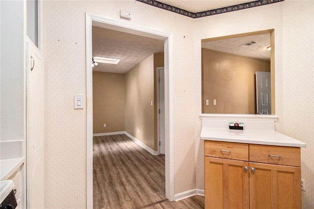 256 Olde Oaks Ln, Riverdale, GA 30274 - bathroom featuring vanity, a textured ceiling, baseboards, and wood finished floors