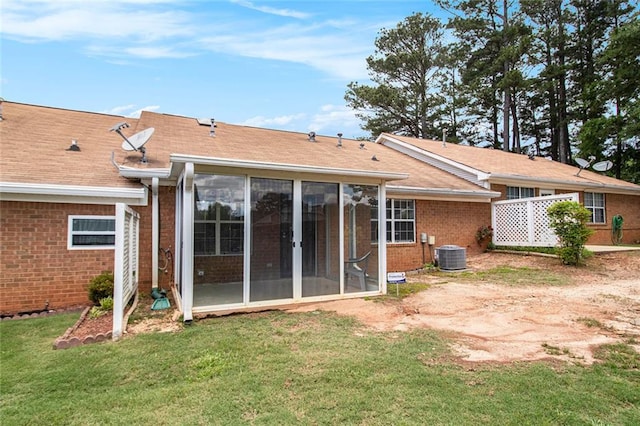 256 Olde Oaks Ln, Riverdale, GA 30274 - back of property featuring central AC, brick siding, a sunroom, and a lawn
