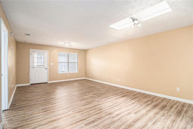 256 Olde Oaks Ln, Riverdale, GA 30274 - unfurnished room with a textured ceiling, baseboards, and light wood-type flooring