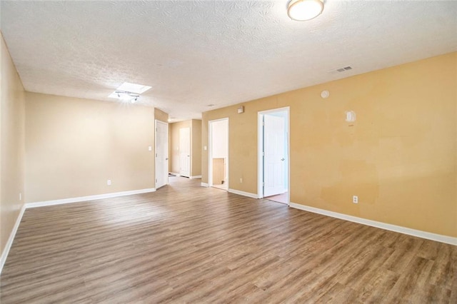 256 Olde Oaks Ln, Riverdale, GA 30274 - spare room featuring a textured ceiling, visible vents, wood finished floors, and baseboards