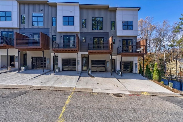 view of property with a garage and driveway