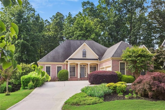 980 Ector Chase NW, Kennesaw, GA 30152 - view of front facade with concrete driveway, brick siding, a garage, a front yard, and a shingled roof