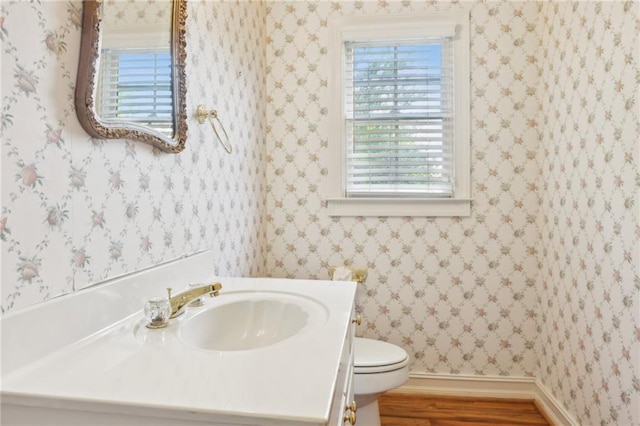 980 Ector Chase NW, Kennesaw, GA 30152 - half bathroom with vanity, toilet, wood finished floors, and baseboards