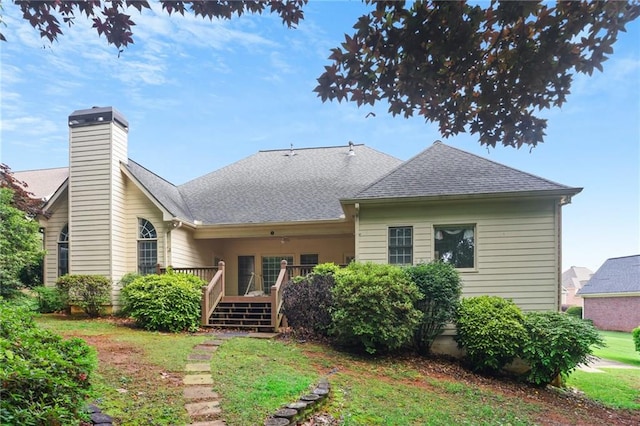 980 Ector Chase NW, Kennesaw, GA 30152 - rear view of house with a wooden deck, a chimney, a shingled roof, and a lawn