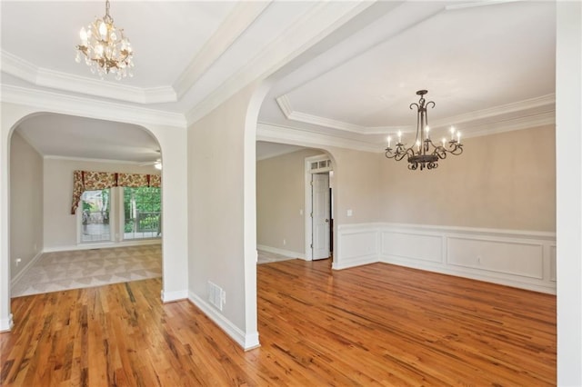 980 Ector Chase NW, Kennesaw, GA 30152 - empty room with arched walkways, a chandelier, crown molding, wood finished floors, and a tray ceiling