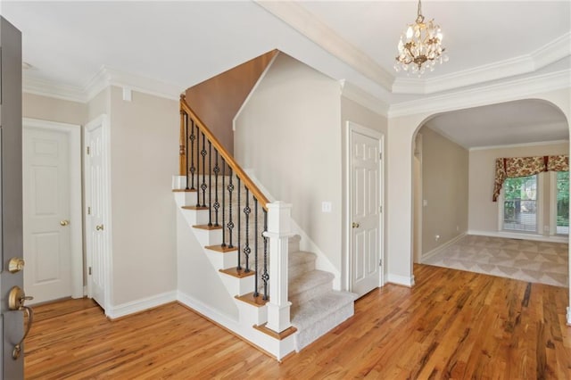 980 Ector Chase NW, Kennesaw, GA 30152 - foyer featuring arched walkways, wood finished floors, ornamental molding, stairs, and baseboards