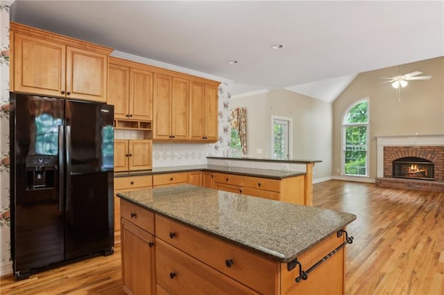980 Ector Chase NW, Kennesaw, GA 30152 - kitchen with black fridge with ice dispenser, light wood finished floors, a kitchen island, a ceiling fan, and lofted ceiling