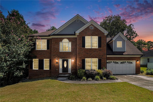 view of front facade featuring a lawn and a garage