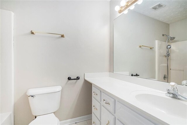 full bathroom with tile patterned flooring, a textured ceiling, toilet, tub / shower combination, and vanity