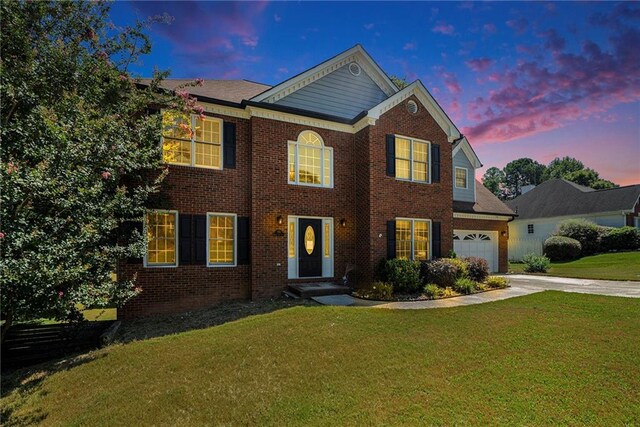 view of front of house with a yard and a garage