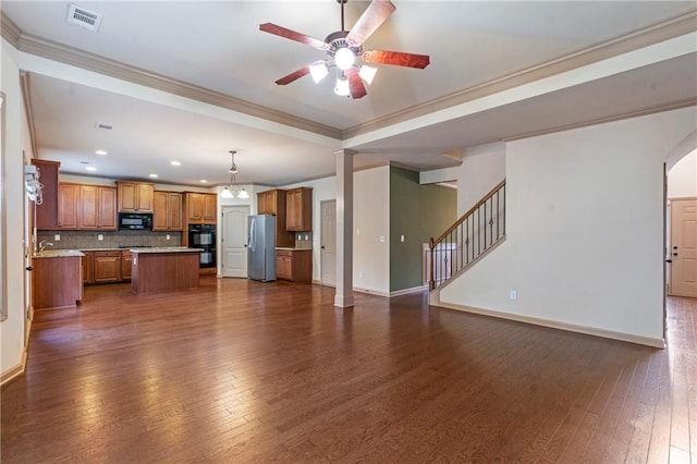 unfurnished living room featuring visible vents, baseboards, dark wood-type flooring, and ceiling fan