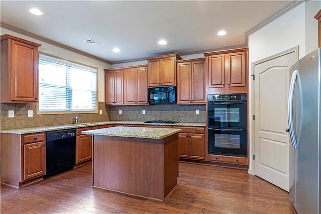 kitchen with crown molding, brown cabinets, dark wood-type flooring, visible vents, and black appliances