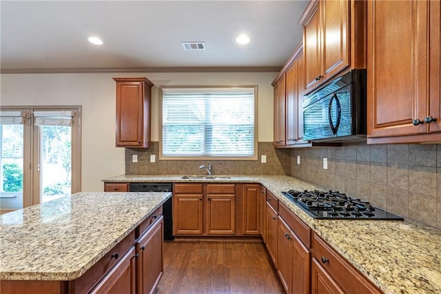 kitchen with crown molding, visible vents, dark wood-style floors, light stone counters, and black appliances