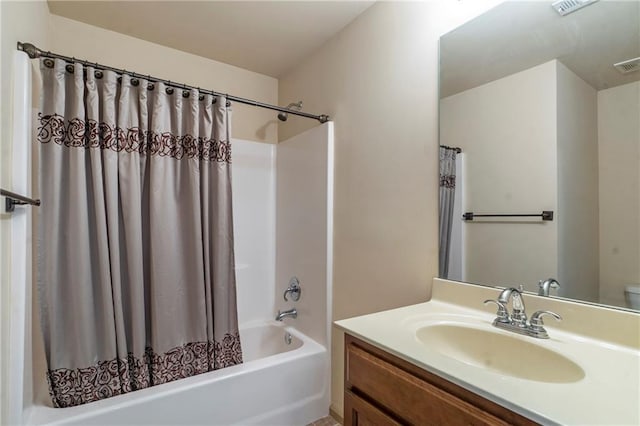 bathroom featuring vanity, shower / bath combo, and visible vents