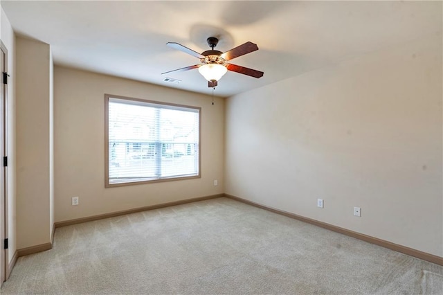 unfurnished room featuring visible vents, baseboards, ceiling fan, and light colored carpet