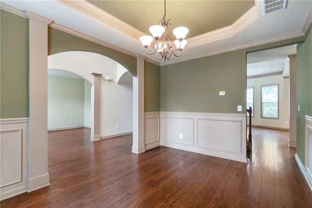 unfurnished dining area featuring visible vents, arched walkways, dark wood finished floors, a wainscoted wall, and an inviting chandelier