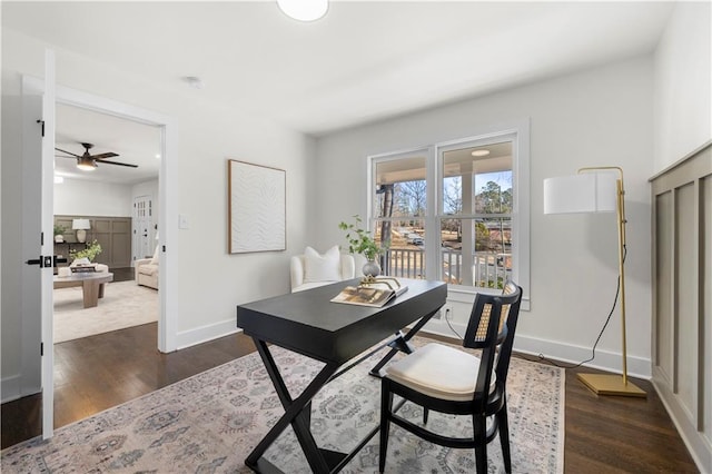 office space featuring dark wood finished floors, baseboards, and ceiling fan