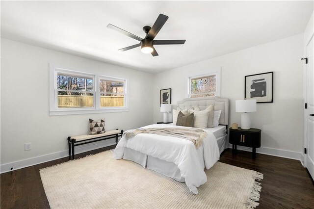 bedroom featuring baseboards, ceiling fan, and dark wood finished floors