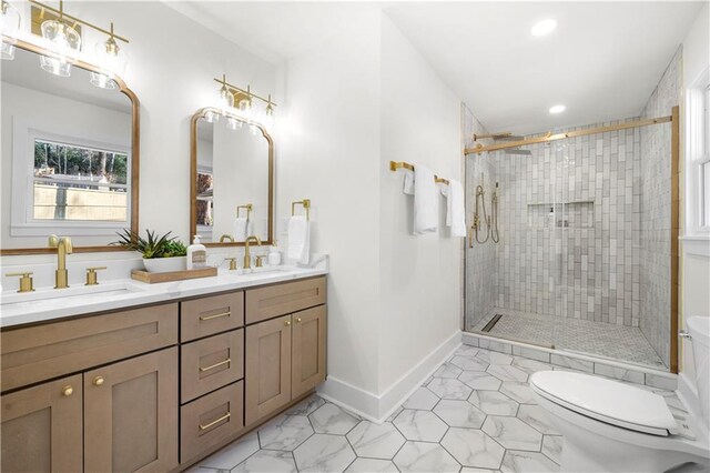 full bathroom featuring double vanity, a sink, toilet, and a shower stall