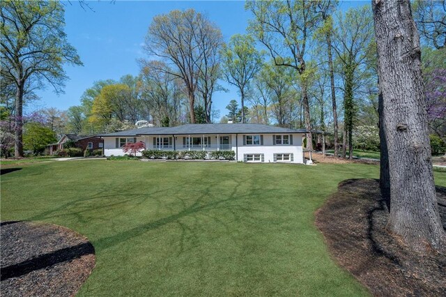 ranch-style home with a front yard
