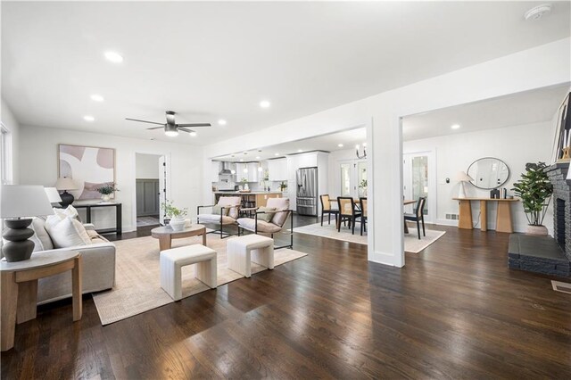 living room with ceiling fan, recessed lighting, and dark wood finished floors