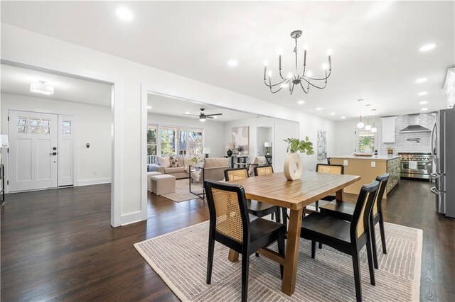 dining area with recessed lighting, ceiling fan with notable chandelier, baseboards, and dark wood finished floors