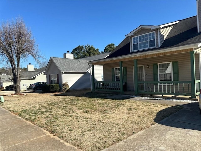 view of front of house featuring a front lawn and covered porch