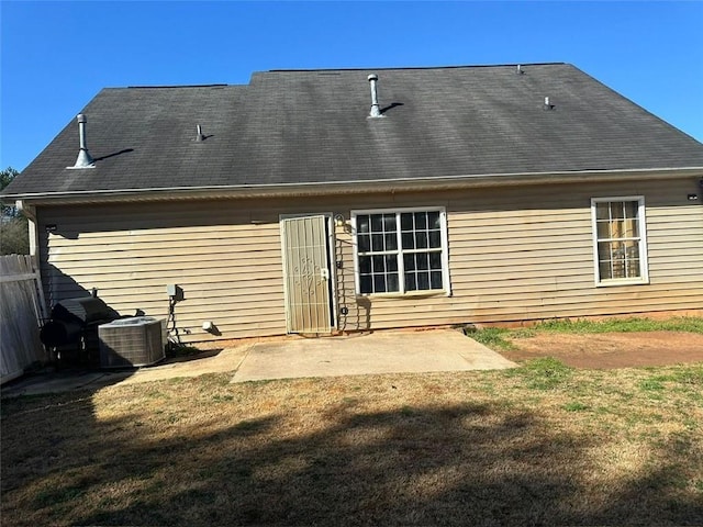 back of house featuring a yard, a patio area, fence, and central AC