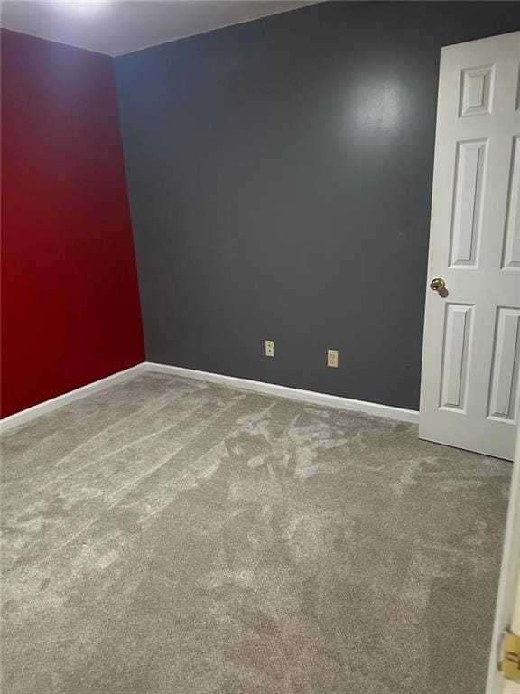 carpeted empty room with baseboards