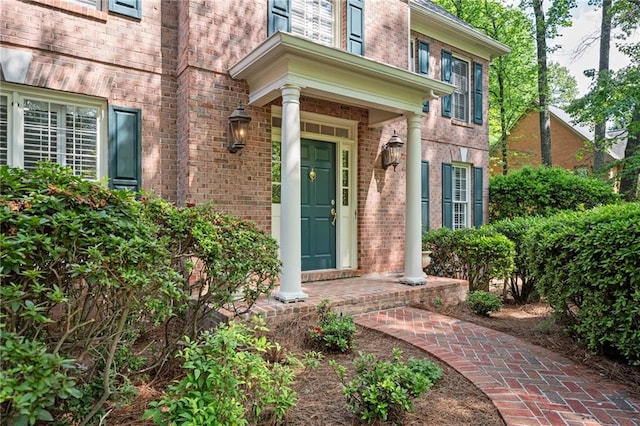 doorway to property with brick siding