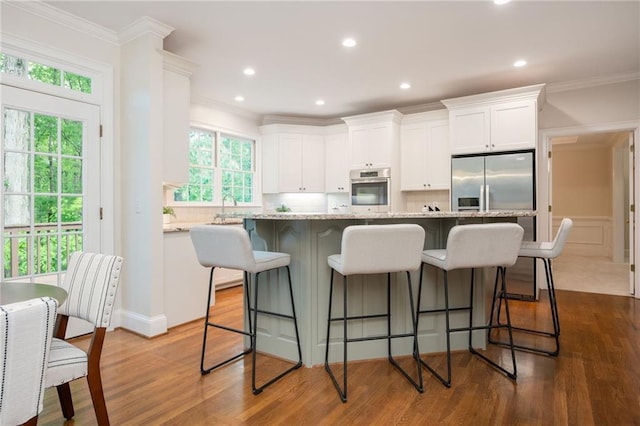 kitchen featuring dark wood-style flooring, stainless steel oven, white cabinets, and tasteful backsplash