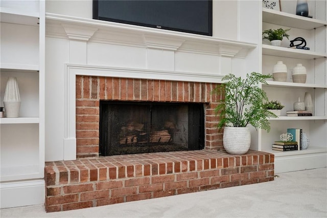 interior details featuring carpet and a brick fireplace
