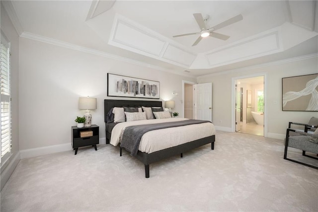 bedroom featuring crown molding, baseboards, light colored carpet, and ensuite bath