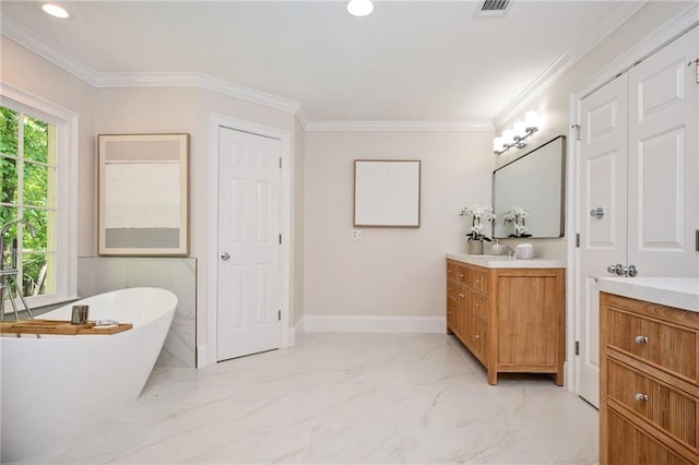 bathroom featuring vanity, marble finish floor, a freestanding tub, baseboards, and recessed lighting