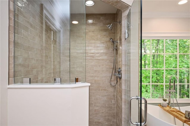 full bathroom with recessed lighting, ornamental molding, a tile shower, and a soaking tub