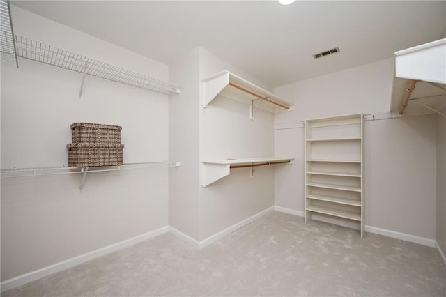 spacious closet with carpet flooring and visible vents