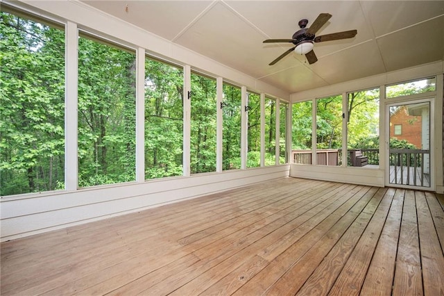 unfurnished sunroom with a ceiling fan