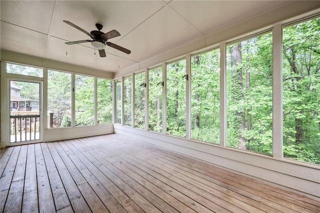 unfurnished sunroom featuring a ceiling fan