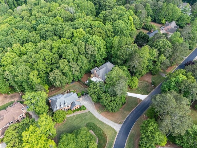 drone / aerial view with a wooded view