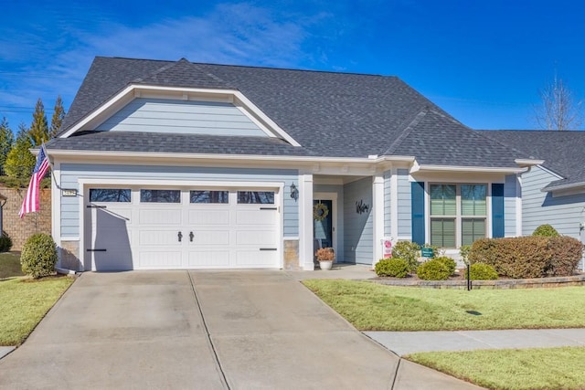 view of front of home with a garage and a front lawn