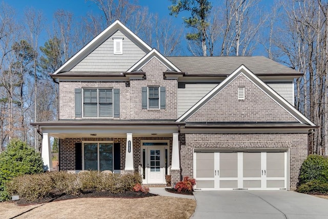 craftsman-style house featuring a garage, concrete driveway, brick siding, and covered porch